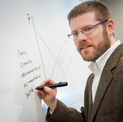 Dr. Ben Gramig writing out an equation