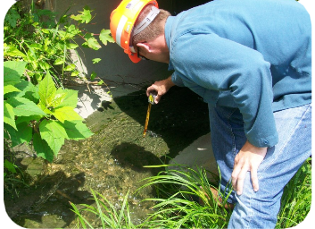 Chrias Goddard taking a water sample