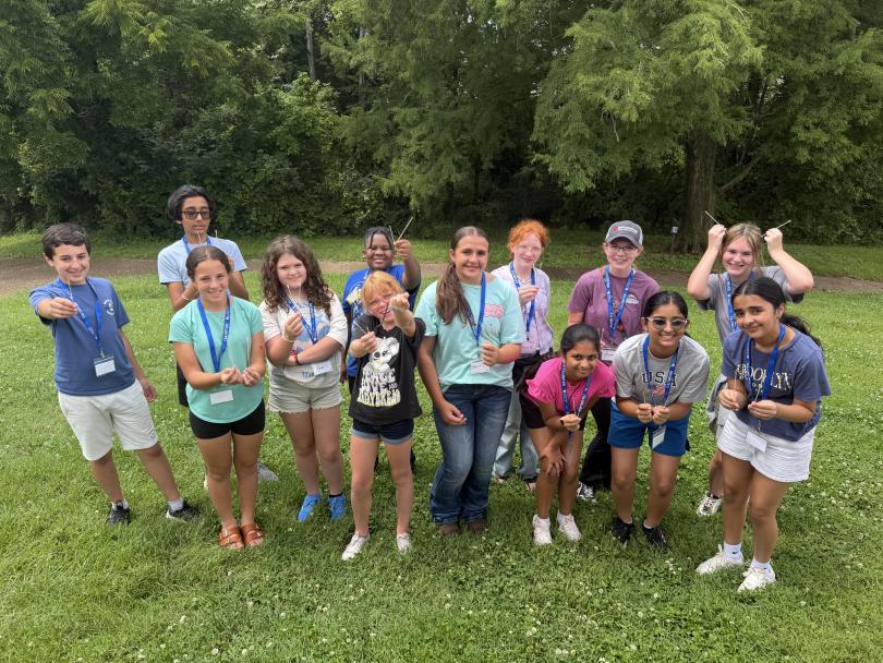 A group of kids smiling at a STEM camp